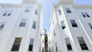 Exterior 10 Copeland, White buildings, alley between buildings, photo taken ground level towards the sky.