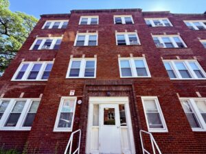 Exterior 54 Holworthy Street, four story red brick building, white windows.